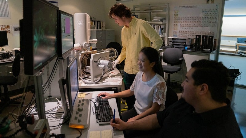 students in a lab looking at a computer